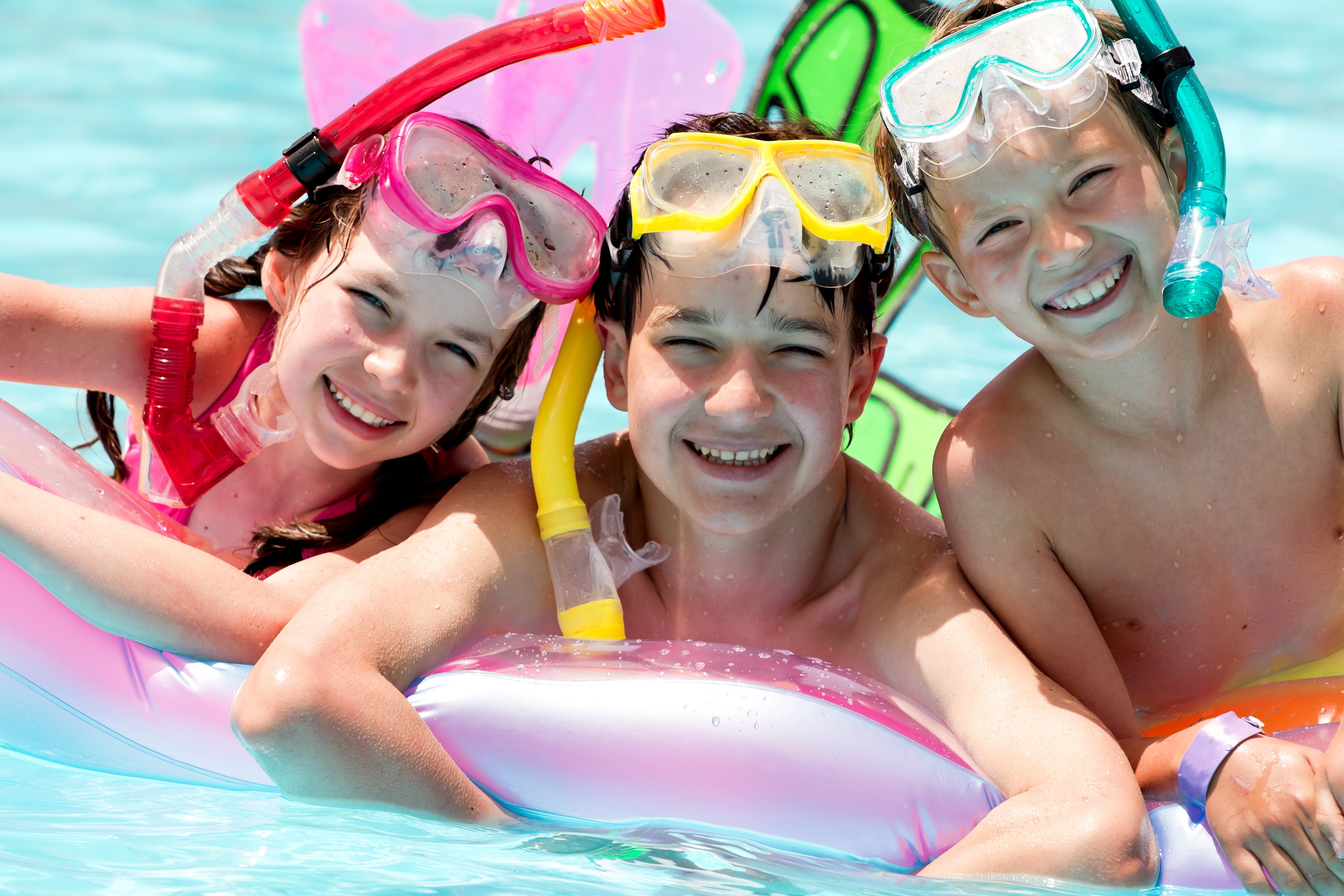 Children wearing swim masks in a pool